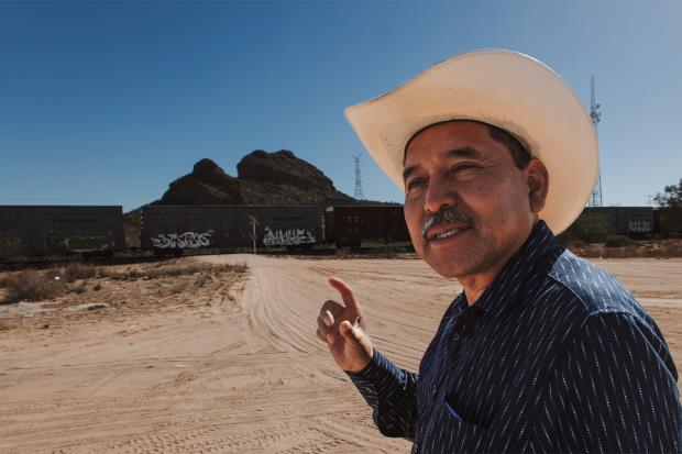 Mario Luna Romero points at one of the four sacred mountains that mark the boundaries of the ancestral Yaqui territory.