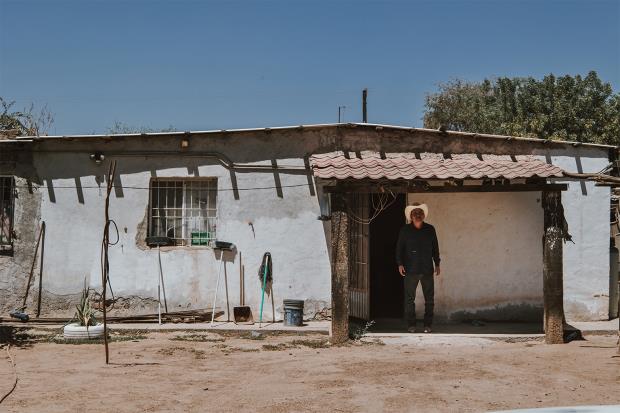 Mario Luna Romero stands outside his house in Vícam, one of eight Yaqui villages in the Yaqui Valley.