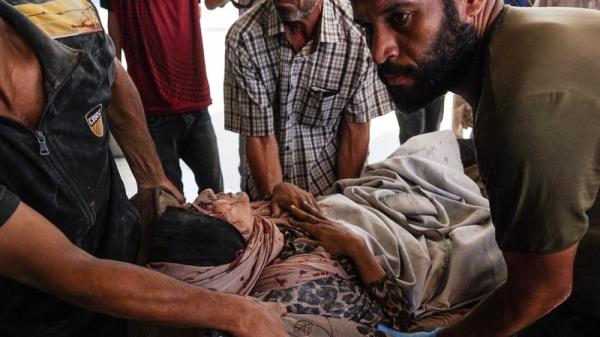 A Palestinian woman is rushed to Nasser Hospital in Khan Younis following Israeli bombardment on Monday